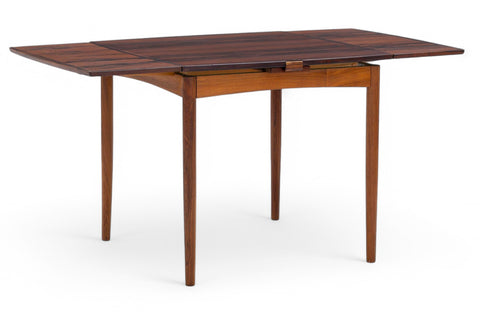 Expandable rosewood dining table with integrated sliding leaves and square profile