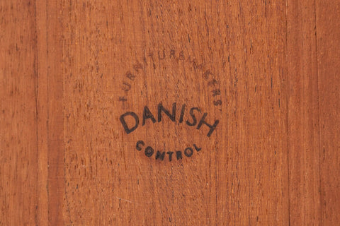 Product shot of an Arne Wahl Iversen rosewood table with bow edges and pull-out leaves