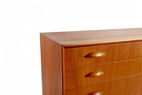 Close-up of teak drawer front and sculpted pull