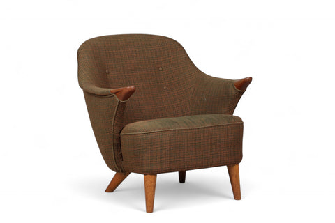 Classic Danish lounge seat with minimalist lines and teak paws