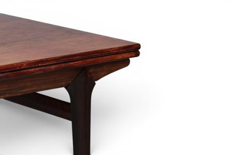 Rosewood grain detail on 1950s Johannes Andersen jet age draw leaf dining table