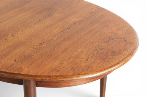 Oval rosewood dining table with one extension leaf installed - 1960s Danish mid century modern