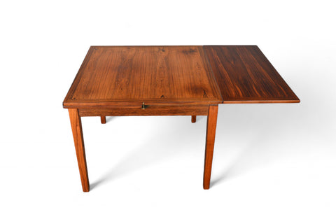 Solid teak small pedestal table in mid-century modern dining setting.