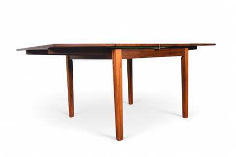 Solid teak small pedestal table with subtle wood grain patterns.