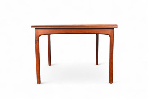 Closed configuration of a teak table, flip-top mechanism concealed for a clean look