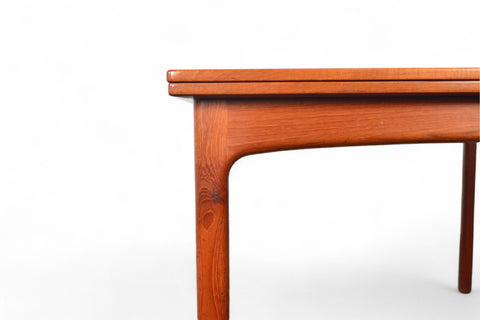 Detail of flip-top hinge and tabletop grain on an elegant teak dining table