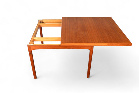 Detail of flip-top hinge and tabletop grain on an elegant teak dining table