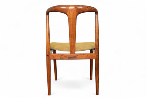 Wooden chair with a beige cushion on a white background