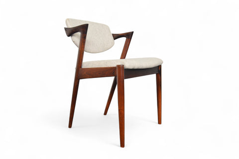 Wooden chair with white cushion on a white background