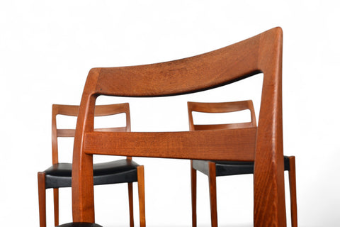 Wooden chairs with black seats on a white background