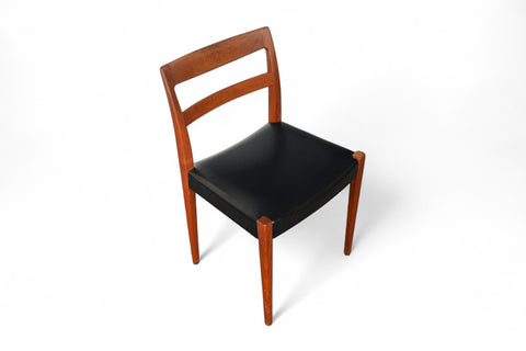 Wooden chair with black seat on a white background