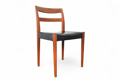 Wooden chair with black seat on a white background