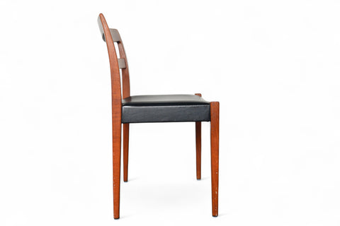 Wooden chair with black seat on a white background