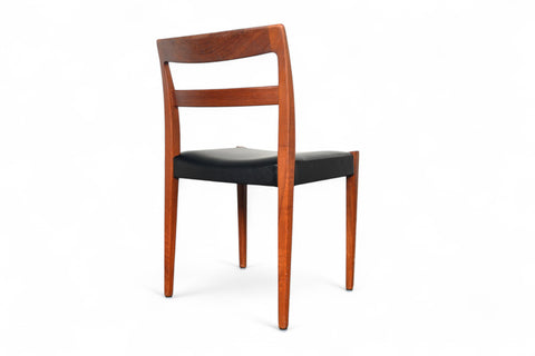 Wooden chair with black seat on a white background