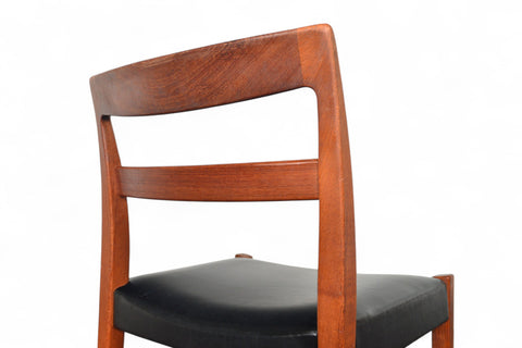 Wooden chair with a black cushion on a white background