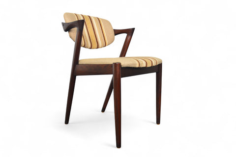 Wooden chairs with striped cushions on a white background