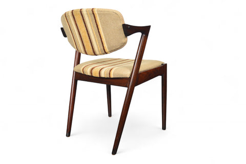 Wooden chairs with striped cushions on a white background