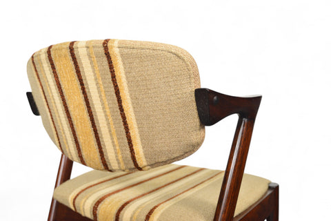 Chair with striped cushion on a white background