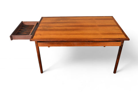 Extended configuration highlighting the rosewood surface and integrated dining table leaves.