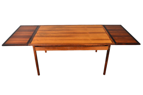 BEAUTIFULLY GRAINED BRAZILIAN ROSEWOOD DINING TABLE WITH STORED LEAVES