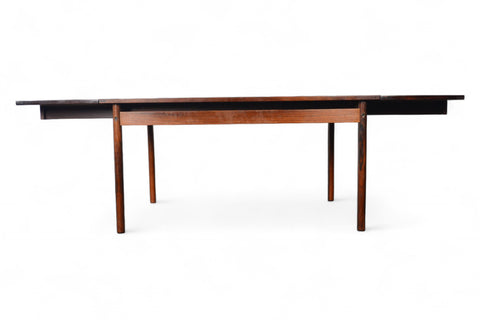 Product shot of a Brazilian rosewood table, focus on the pronounced grain and built-in leaves.