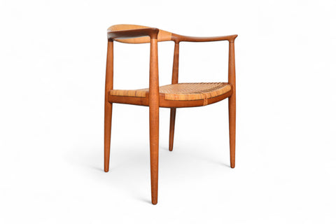 Classic Hans Wegner Round Chair, cane seat supported by teak curved arms