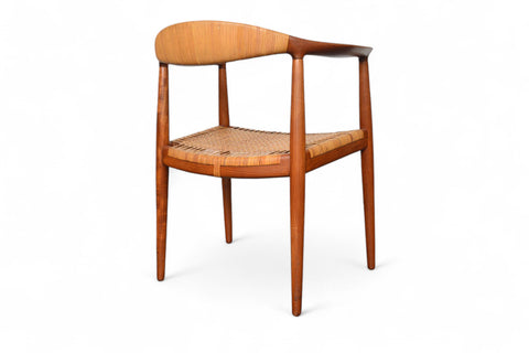 Danish modern teak chair by Hans Wegner, cane seat and iconic semicircular arm-back
