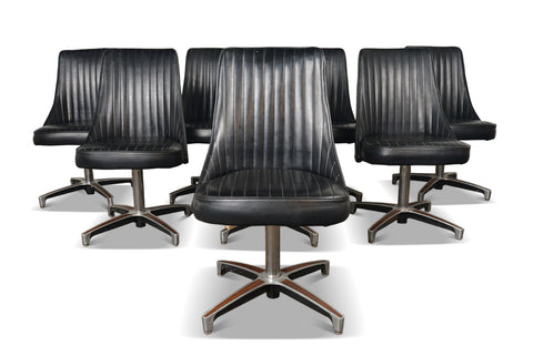 Black vinyl Chromcraft lounge chairs on aluminum swivel bases with walnut inlays