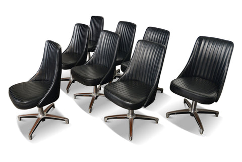 Eight Chromcraft lounge chairs, black vinyl upholstery, aluminum swivel base
