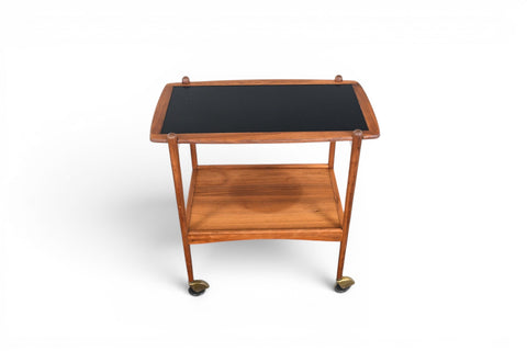 1960s Danish modern walnut bar cart with black laminate shelf, angled view