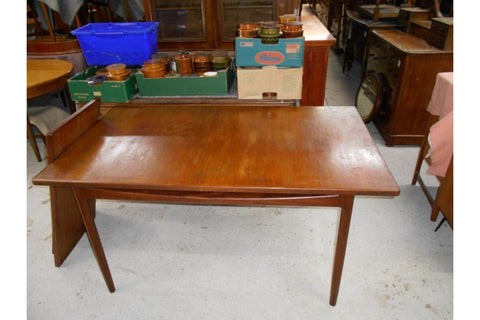 Ib Kofod-Larsen Danish Range extendable teak dining table shown in a mid-century modern interior