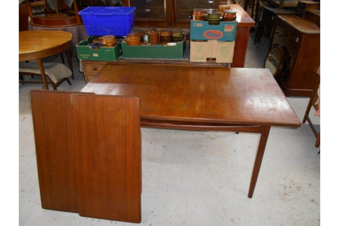 Extendable teak dining table with clean Scandinavian lines and refined craftsmanship
