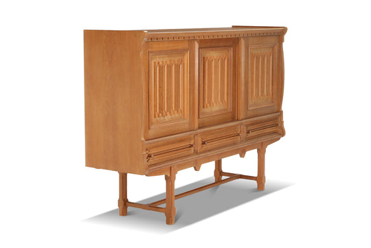 TALL OAK SIDEBOARD IN THE MANNER OF HENRY KJAERNULF