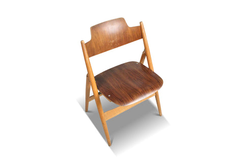 Mid-century plywood seat chairs with A-frame legs shown in multiples