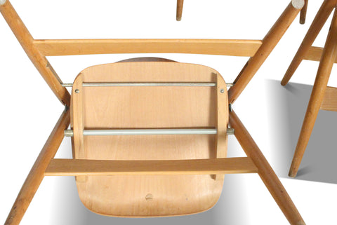 Close-up of underside hinges and supports on a folding dining chair