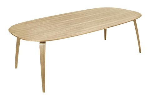 Gubi elliptical dining table with a Oak Semi Matte Lacquered finish