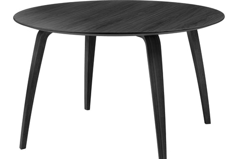 Round wooden dining table by Gubi
