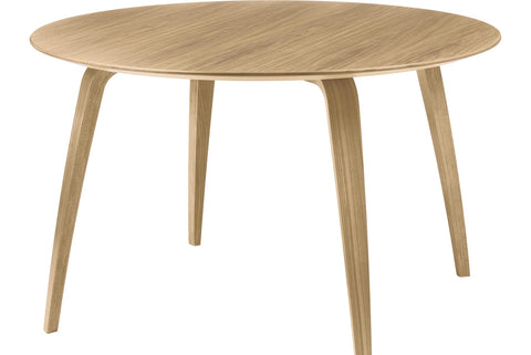 Round wooden dining table by Gubi