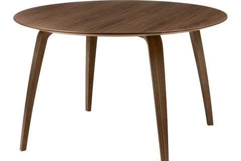 Round wooden dining table by Gubi