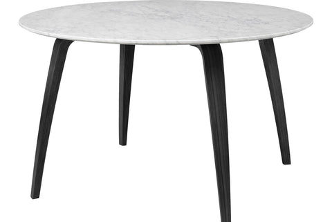 Round wooden dining table by Gubi